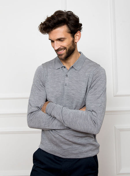 Man wearing silver grey long sleeved polo neck sweater knit in 100% luxury and premium merino wool.
